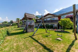 a yard with a playground and a house at Krebishof Agriturismo in Schenna