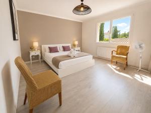 a bedroom with a bed and a chair and a window at Haut de Villa Bianca - Spacious - Quiet in Saint-Raphaël +24 photos