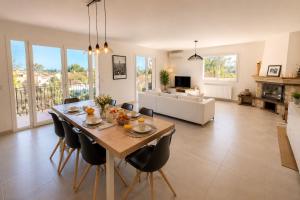 a dining room and living room with a table and chairs at Haut de Villa Bianca - Spacious - Quiet in Saint-Raphaël