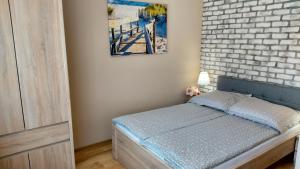 a bedroom with a bed with a brick wall at Willa Sternik in Hel +62 photos