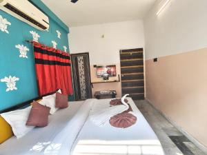 a bedroom with a bed in a room at Hotel Lotus in kolkata