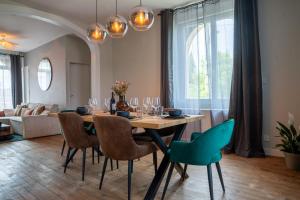 a dining room with a table and chairs at 1 Peraudel Suite & Appartements in Castres