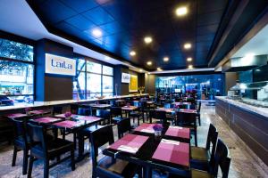 a restaurant with tables and chairs with pink napkins at LaiLa Hotel Mexico City Reforma in Mexico City +68 photos