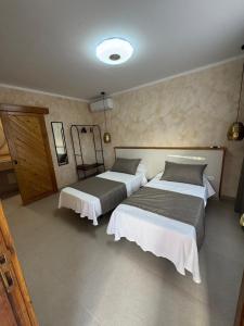 a bedroom with two beds and a mirror at Villa Majora - Piscina climatizada in Tuineje +3 photos