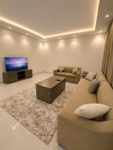 a living room with a couch and a tv at Comfort Stay 3 in Taif +3 photos