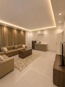 a large living room with a couch and a kitchen at Comfort Stay 3 in Taif