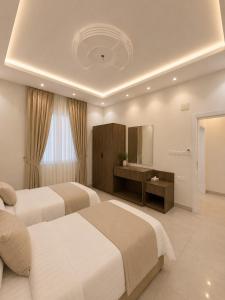 a hotel room with two beds and a sink at Comfort Stay 3 in Taif