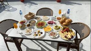 a table with plates of food on top of it at Pyramids Giza inn in Cairo