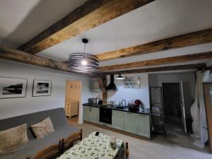 a living room with a table and a kitchen at Barn - Nocleg na Mazurach in Sołtmany