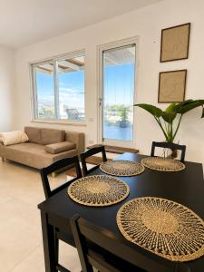 a living room with a table and chairs and a couch at פלג טל -דפנה in Dafna