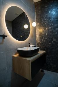 a bathroom with a black bowl sink and a mirror at Douro River Apartment in Vila Nova de Foz Coa +67 photos