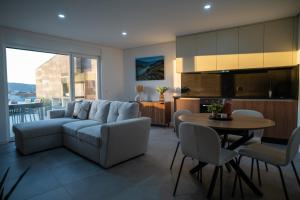 a living room with a couch and a table at Douro River Apartment in Vila Nova de Foz Coa