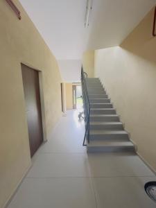 an empty hallway with stairs in a building at Apartament Maja 10-3 in Nowy Sącz +3 photos