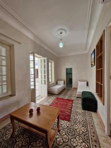 a living room with a bed and a coffee table at Riad Rabat Laalou in Rabat