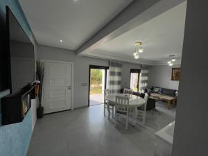 a living room with a table and a dining room at VILLA EVASION Aglou Center in Zaouia Sidi Ouaggag