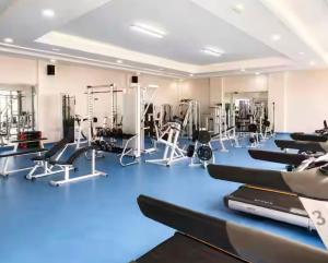 a gym with several treadmills and exercise machines at VILLA EVASION Aglou Center in Zaouia Sidi Ouaggag
