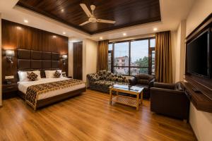 a bedroom with a bed and a flat screen tv at The Valley View in Srinagar