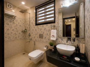 a bathroom with a white toilet and a sink at The Valley View in Srinagar +4 photos