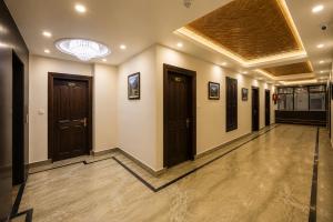 a hallway with brown doors and a ceiling at The Valley View in Srinagar