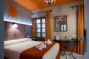 a hotel room with two beds and a lamp at Casual Don Juan Tenorio Sevilla in Seville