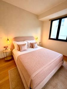 a bedroom with a large bed with pillows and a window at Le Charme Luxury Suite in Patti +11 photos