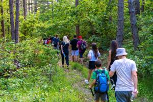 a group of people walking on a trail in the woods at Seosko domaćinstvo Kastratović in Berane