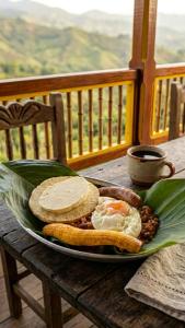 a plate of food with eggs and bread on a table at Los Arrieros - Hospedaje Rural in Manizales