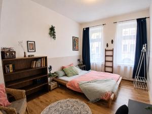 a bedroom with a bed and a book shelf at The Boho Hideaway in Leutsch in Leipzig