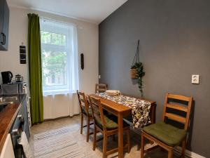 a dining room with a table and chairs and a window at The Boho Hideaway in Leutsch in Leipzig +29 photos