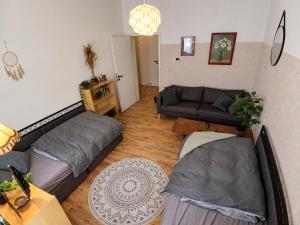 a living room with two beds and a couch at The Boho Hideaway in Leutsch in Leipzig