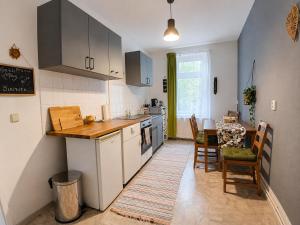 a kitchen with a table and a dining room at The Boho Hideaway in Leutsch in Leipzig