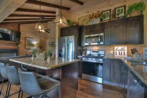 a kitchen with stainless steel appliances and wooden cabinets at Blueberry Hill Fire Pit MTN Views Grill in McCaysville