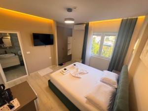 a room with a bed and a couch and a mirror at London Restaurant Hotel in Kukës +116 photos