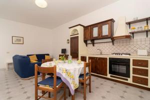 a kitchen with a table with chairs and a dining room at Limoneto by Espresso Rentals in Massa Lubrense