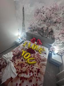 a bedroom with a bed with the word love on it at The Paris Rooms B&B in Reggio di Calabria +36 photos
