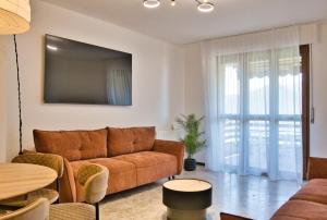a living room with a couch and a table at Renzo e Lucia - la Terrazza Panoramica in Barzio