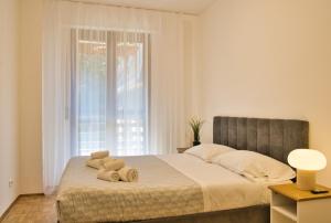 a bedroom with a bed with two teddy bears on it at Renzo e Lucia - la Terrazza Panoramica in Barzio