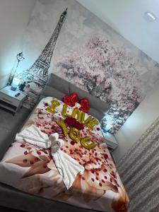 a bedroom with a bed with flowers and the eiffel tower at The Paris Rooms B&B in Reggio di Calabria