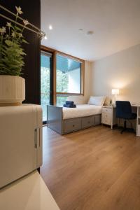 a bedroom with a bed and a desk and a chair at Beacon Guest Rooms Sandyford in Sandyford