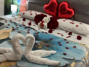 a bed covered in hearts and two swans at The Paris Rooms B&B in Reggio di Calabria