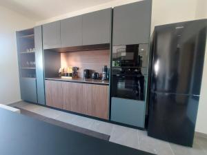 a large kitchen with a stainless steel refrigerator at Dani & Fani suite in Afantou