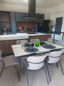 a kitchen with a table and chairs with wine glasses at Dani & Fani suite in Afantou