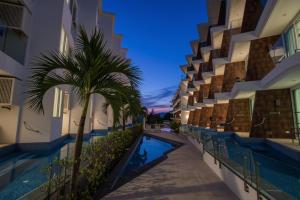 a rendering of a building with a swimming pool and a palm tree at Beachfront A405 Seaview Studio Rawai Phuket in Ban Saiyuan (1)