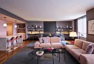 a living room with a couch and a table at Loews Chicago O'Hare Hotel in Rosemont