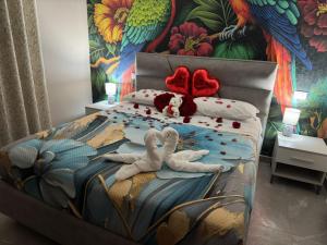 a bedroom with two stuffed animals laying on a bed at The Paris Rooms B&B in Reggio di Calabria