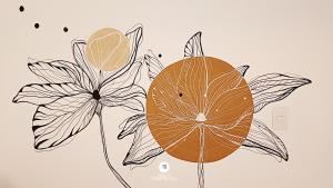 a drawing of an orange and flowers on a wall at Pousada Solar das Pétalas - Florianópolis/SC in Florianópolis