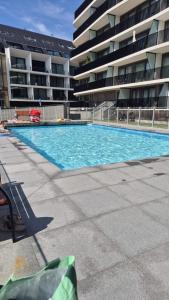 an empty swimming pool in front of a building at Christel Residence in Ostend