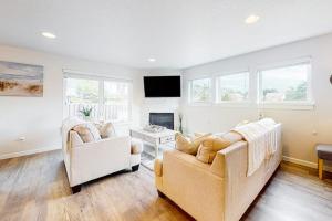 a living room with two couches and a fireplace at Dory Pointe Dream in Pacific City