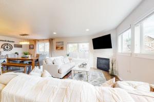 a living room with a large bed and a fireplace at Dory Pointe Dream in Pacific City