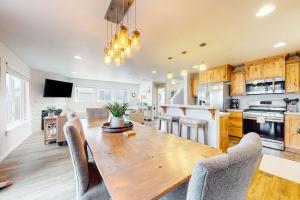 a kitchen and dining room with a wooden table and chairs at Dory Pointe Dream in Pacific City